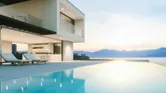 Modern luxury house with infinity pool over the ocean at sunset.